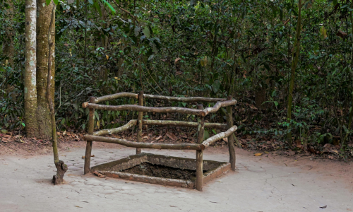 Hidden trapdoor entrance to the Cu Chi Tunnels underground network near Ho Chi Minh City Vietnam
